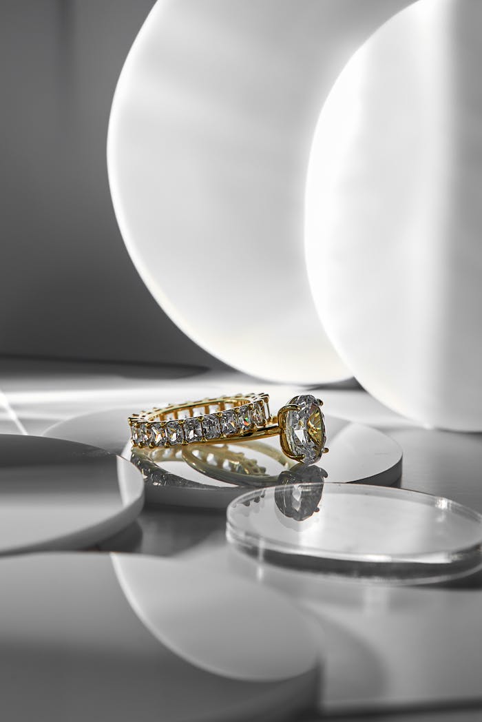 Gold and diamond rings elegantly displayed on a minimalist background with a modern aesthetic.